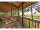 Relaxing screened porch with wooden floors and views of the lush marsh and waterway at 226 Old House Ln, Dewees Island, SC 29451