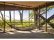 Relaxing screened in porch with hammock overlooking a lush coastal landscape at 226 Old House Ln, Dewees Island, SC 29451