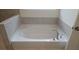Bathroom featuring a large white soaking tub with tile surround and chrome fixtures at 259 Huguenot Trl, Huger, SC 29450