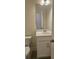Powder room includes single sink vanity, white cabinets, tile floors and modern faucet at 259 Huguenot Trl, Huger, SC 29450