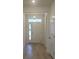 Inviting entryway with wood-look tile flooring and a modern glass-paneled front door at 259 Huguenot Trl, Huger, SC 29450