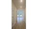 Clean hallway with wood floors leading to a bright living area and neutral walls at 259 Huguenot Trl, Huger, SC 29450