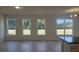 Bright living room with large windows overlooking the backyard and an open concept design at 259 Huguenot Trl, Huger, SC 29450