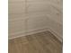 Spacious walk-in closet with shelving for storage and organization with wood flooring at 259 Huguenot Trl, Huger, SC 29450