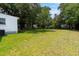 Sprawling backyard showcasing mature trees, lush green grass, and ample space at 2608 Seymour Ave, North Charleston, SC 29405
