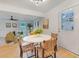 This open-concept room offers dining and living areas with lots of natural light from door and windows at 2608 Seymour Ave, North Charleston, SC 29405