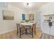 Bright dining area with wooden floor, white door to outside and art offers a cozy dining experience at 2608 Seymour Ave, North Charleston, SC 29405