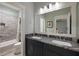 Bathroom features a double vanity with granite countertop, wood cabinets, framed mirror, and tub/shower combo at 2879 River Vista Way, Mount Pleasant, SC 29466