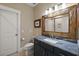 Stylish bathroom with custom wood frame mirror, granite countertop, and modern fixtures at 2879 River Vista Way, Mount Pleasant, SC 29466