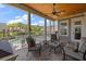 Relaxing covered porch with ceiling fan, outdoor furniture, and a view of the sparkling pool and landscaped yard at 2879 River Vista Way, Mount Pleasant, SC 29466