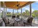 Inviting covered porch with a ceiling fan, fireplace, and comfortable seating area with beautiful views of the outdoors at 2879 River Vista Way, Mount Pleasant, SC 29466