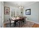 Bright dining area with rustic table, modern chandelier, and ample natural light at 2879 River Vista Way, Mount Pleasant, SC 29466