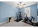 Home gym features blue walls, fan, window with plantation shutters, carpeted floor and exercise equipment at 2879 River Vista Way, Mount Pleasant, SC 29466