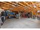 Spacious garage with exposed wood beams, ample storage shelving, and an organized layout for parking and projects at 2879 River Vista Way, Mount Pleasant, SC 29466