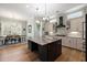 Elegant kitchen featuring a large center island, stainless appliances, and stylish pendant lighting at 2879 River Vista Way, Mount Pleasant, SC 29466