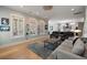 Bright living room boasts large windows, hardwood flooring, comfortable seating, and stylish decor at 2879 River Vista Way, Mount Pleasant, SC 29466