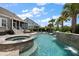 The backyard features a sparkling pool with a spa, waterfall, and inviting patio for outdoor enjoyment and relaxation at 2879 River Vista Way, Mount Pleasant, SC 29466