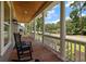 Relaxing front porch with wood flooring, rocking chair, and white pillar accents at 2879 River Vista Way, Mount Pleasant, SC 29466