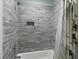 Clean and updated shower with stylish gray tile and a shower curtain for a modern look at 2879 River Vista Way, Mount Pleasant, SC 29466