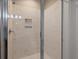 Modern shower with light stone colored tile and glass door, offers a sleek and clean design at 2879 River Vista Way, Mount Pleasant, SC 29466