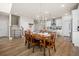 Traditional wood dining table in open-concept dining room with view into kitchen and entry staircase at 291 Lucca Dr, Summerville, SC 29486