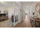 Bright hallway with hardwood floors leading to a study with French doors at 291 Lucca Dr, Summerville, SC 29486