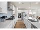 Modern kitchen with white cabinets, stainless steel appliances, and hardwood floors at 291 Lucca Dr, Summerville, SC 29486