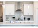 Close up of kitchen with stainless steel hood and light blue tiled backsplash at 291 Lucca Dr, Summerville, SC 29486