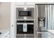 Stainless steel microwave and oven are built into white cabinets next to a stainless refrigerator at 291 Lucca Dr, Summerville, SC 29486