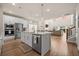 Open concept kitchen with island seating flows into the dining area and living room at 291 Lucca Dr, Summerville, SC 29486