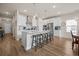 Open concept kitchen with island seating flows into the dining area and living room at 291 Lucca Dr, Summerville, SC 29486