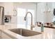 Modern kitchen sink with stainless steel faucet and soap dispenser on bright quartz countertop at 291 Lucca Dr, Summerville, SC 29486