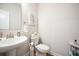 Well-lit powder room with pedestal sink, modern faucet, and stylish decor at 291 Lucca Dr, Summerville, SC 29486