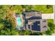 Aerial view of backyard with a pristine pool, lounge chairs, a fire pit, gazebo, and solar panels at 2997 Sturbridge Rd, Mount Pleasant, SC 29466