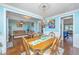 Open-concept dining room leading to a living room with hardwood floors and chandelier at 2997 Sturbridge Rd, Mount Pleasant, SC 29466