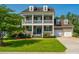 Charming two-story home with a manicured lawn, inviting front porch, and attached garage at 2997 Sturbridge Rd, Mount Pleasant, SC 29466