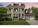 Charming two-story home with double porches, a well-manicured lawn, and a two-car garage at 2997 Sturbridge Rd, Mount Pleasant, SC 29466