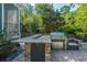 Outdoor kitchen and BBQ area featuring a granite countertop, built-in grill, and stone accents at 2997 Sturbridge Rd, Mount Pleasant, SC 29466