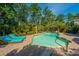 Inviting backyard pool with lounge chairs and a gazebo, surrounded by lush greenery and blue skies at 2997 Sturbridge Rd, Mount Pleasant, SC 29466