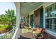 Inviting front porch with cozy seating, a vibrant rug, and views of the well-manicured front yard at 2997 Sturbridge Rd, Mount Pleasant, SC 29466