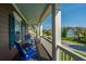 Charming front porch with blue chairs offering a scenic view of the neighborhood and lush landscape at 2997 Sturbridge Rd, Mount Pleasant, SC 29466