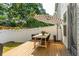 Charming backyard deck with a dining table, chairs, striped umbrella, and string lights along the fence at 3082 Emma Ln, Mount Pleasant, SC 29466