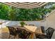 Cozy backyard deck with a dining table, chairs, striped umbrella, and serene green surroundings at 3082 Emma Ln, Mount Pleasant, SC 29466