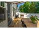 Inviting backyard deck with a grill, table, chairs, and a striped umbrella, perfect for outdoor dining at 3082 Emma Ln, Mount Pleasant, SC 29466