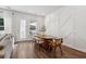 Dining room with wood floors, a dining table with modern chairs, and wainscoting on the walls at 3082 Emma Ln, Mount Pleasant, SC 29466