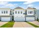 Charming townhomes feature white and gray exteriors, attached garages, and a concrete driveway at 3082 Emma Ln, Mount Pleasant, SC 29466