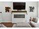 Bright living room features fireplace, mounted TV, and decorative black and white artwork on the walls at 3082 Emma Ln, Mount Pleasant, SC 29466