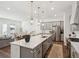 Modern kitchen boasts a large island, stainless steel appliances, and pendant lighting at 3082 Emma Ln, Mount Pleasant, SC 29466