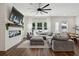 Spacious living room with a fireplace, mounted TV, large sectional, and view of backyard at 3082 Emma Ln, Mount Pleasant, SC 29466