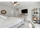 Bright main bedroom featuring a ceiling fan, TV, dresser, and decorative shelving unit at 3082 Emma Ln, Mount Pleasant, SC 29466